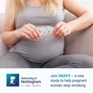 Pregnant woman breaking a cigarette in two