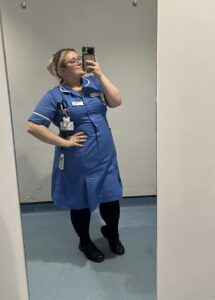 Holly GIles in nursing uniform taking a selfie